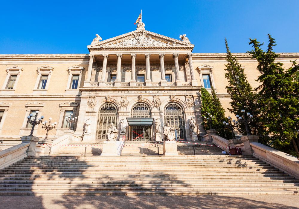 The Archaeological Museum and National Library of Madrid with a blue sky in the background.