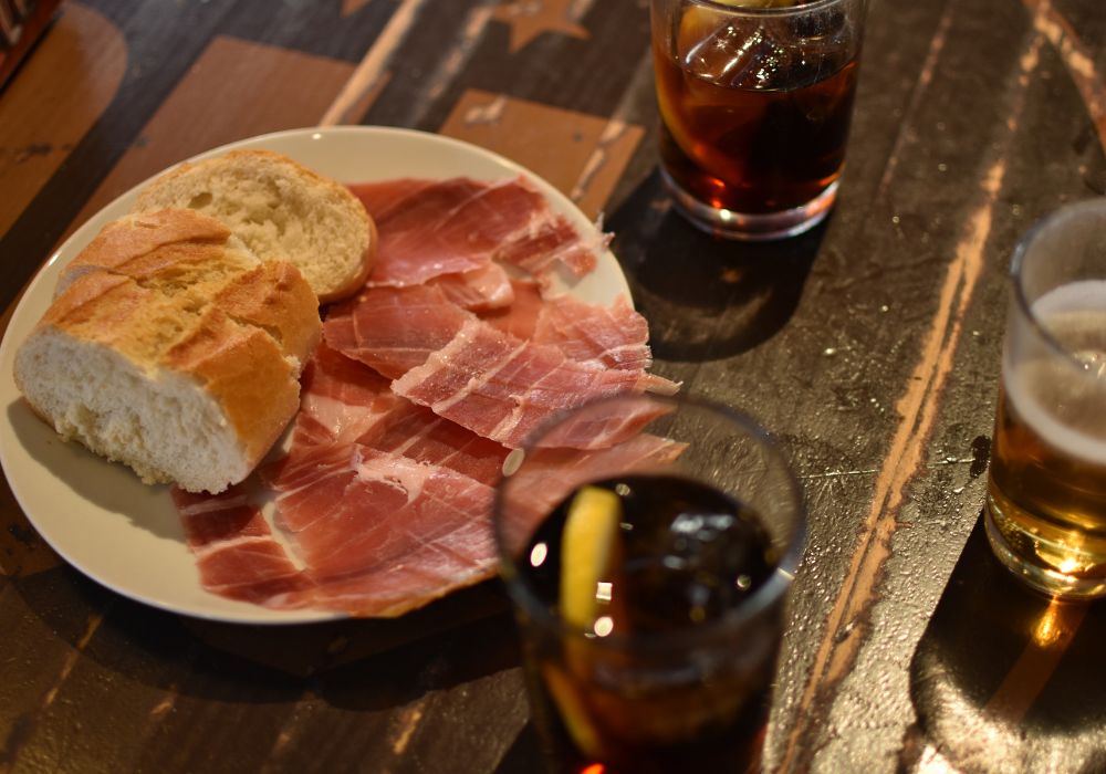 Spanish cured ham along with vermouth and beer in traditional bar in Madrid.