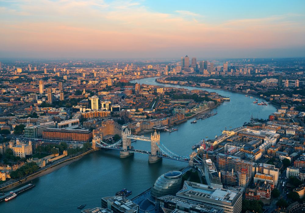 London rooftop panorama view at sunset with urban architectures and Thames River.