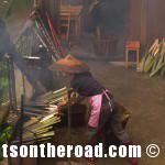 Village woman cooking rice in bamboo, Dragon's Backbone Rice Terraces, China