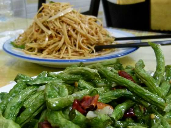 chinese food in china eating green beans and shredded tofu when backpacking china