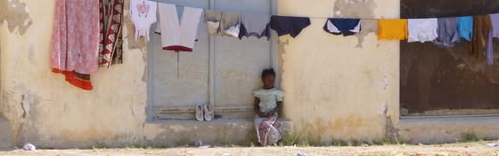 Mozambique Travel - A Girl In Front Of An Old Portugese House