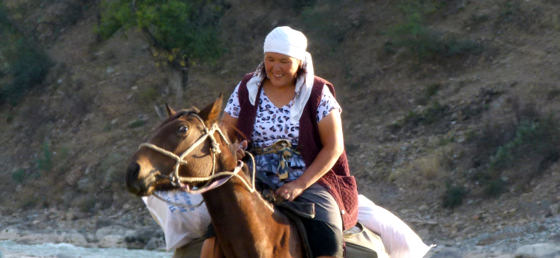 Kyrgyz Woman On A Horse