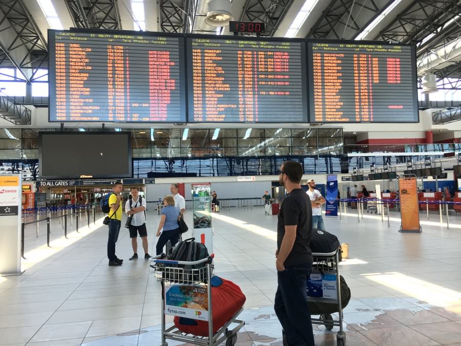 travel planning looking at departure board prague airport