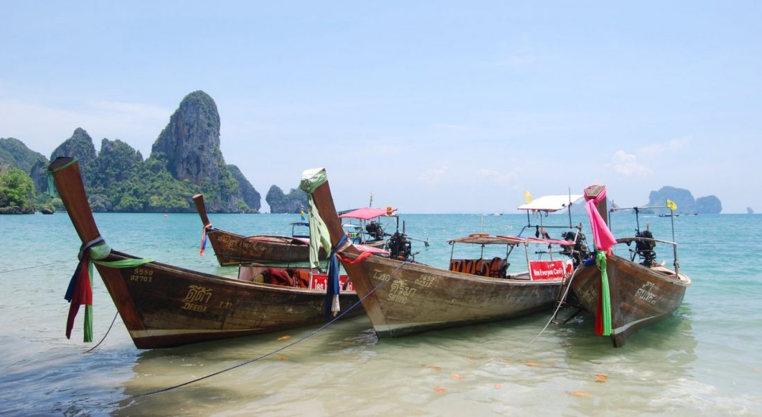 take a longtail boat when visiting thailand 