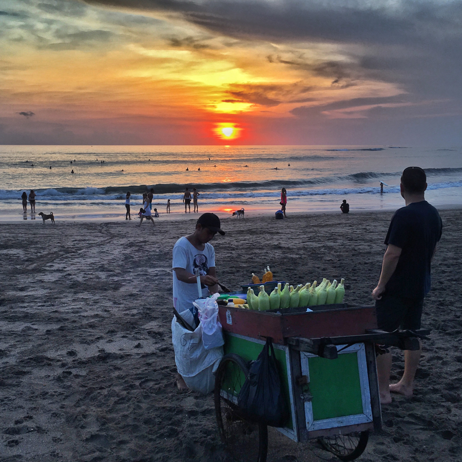 watching sunset on canggu beach with grilled corn