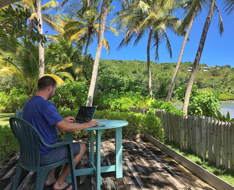 Nick on the porch in Grenada living and working remotely