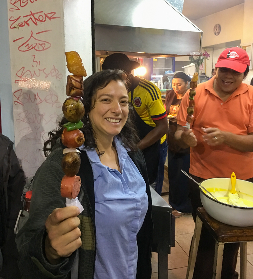 sampling different skewers on a food tour in quito