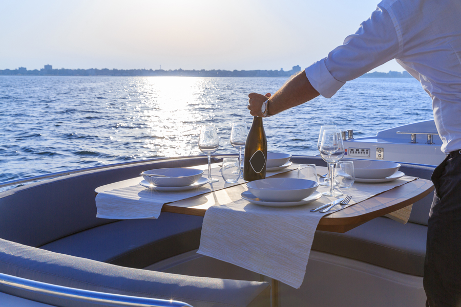 serving passengers wine while working on a yacht