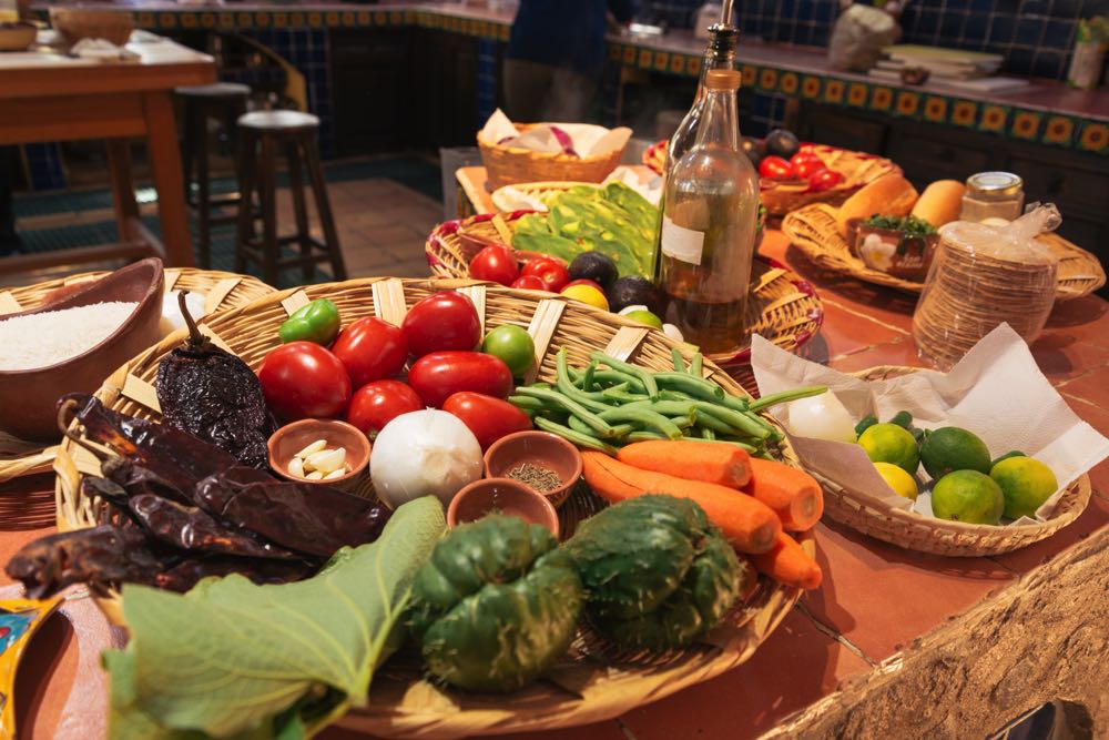 Hand-woven baskets of fresh ingredients for a cooking class in Merida