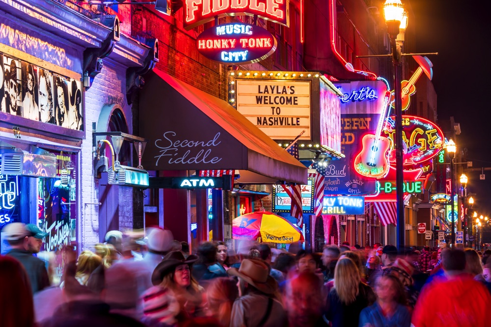 party on a weekend in nashville neon signs and people