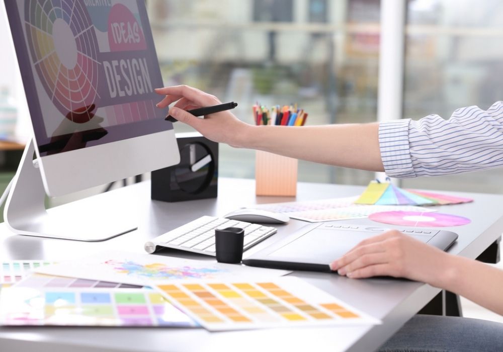 woman at her computer working as a graphic designer making money online 