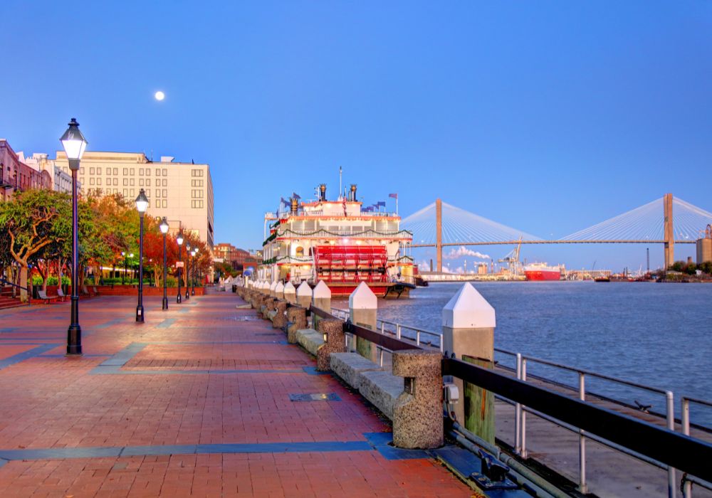 An empty street with lamp posts along the water in Savannah, Georgia