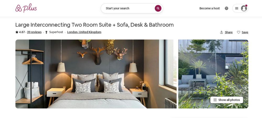 A cozy king-sized bed and a choice of pillows with neutral tones and some decorations hanging on the wall.