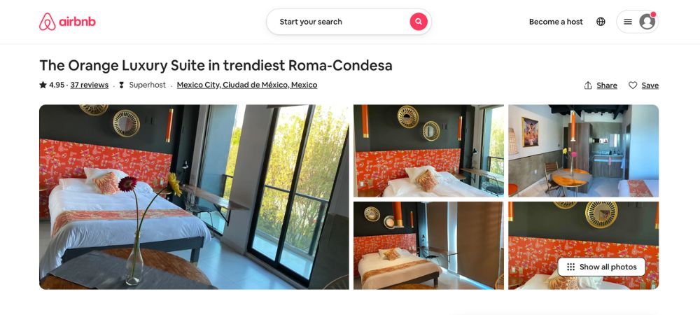 The apartment contains high-quality furniture and appliances, a queen-size bed, and a small kitchen.