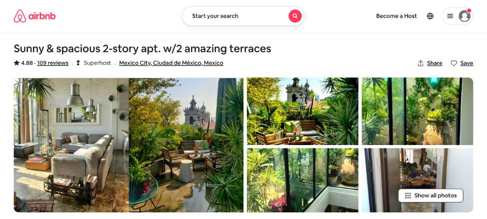 It has a cozy interior and is decorated with plenty of plants and greenery in the area.
