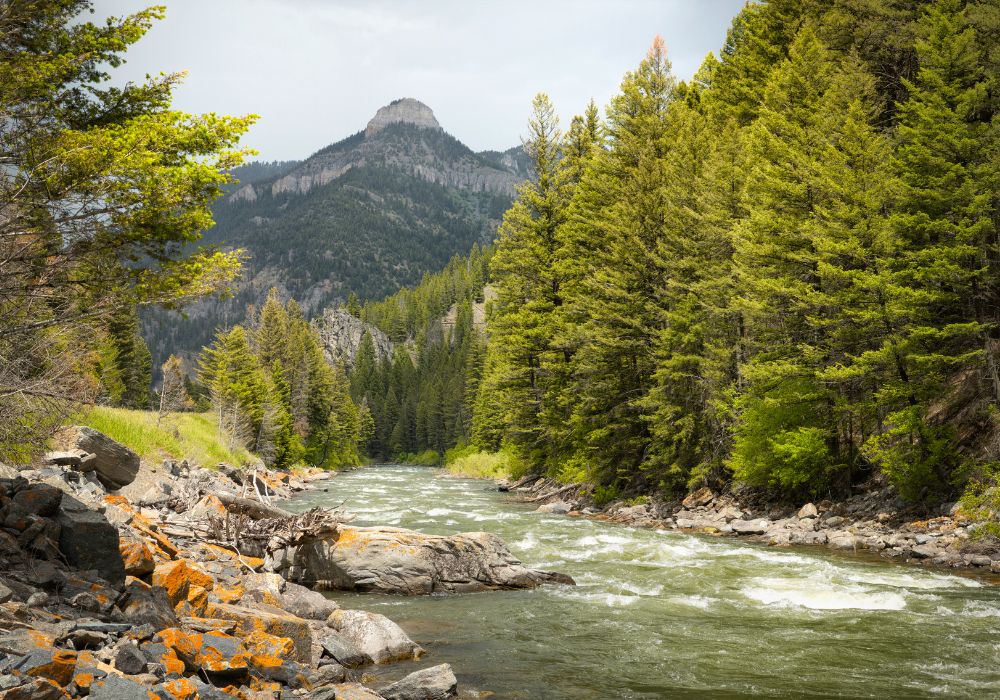 Gallatin River under a dramatic sky in Montana. Garnet Mountain in the background.