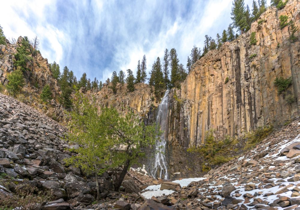 The stunning Palisade Falls in Montana during winter in a clear blue sky.