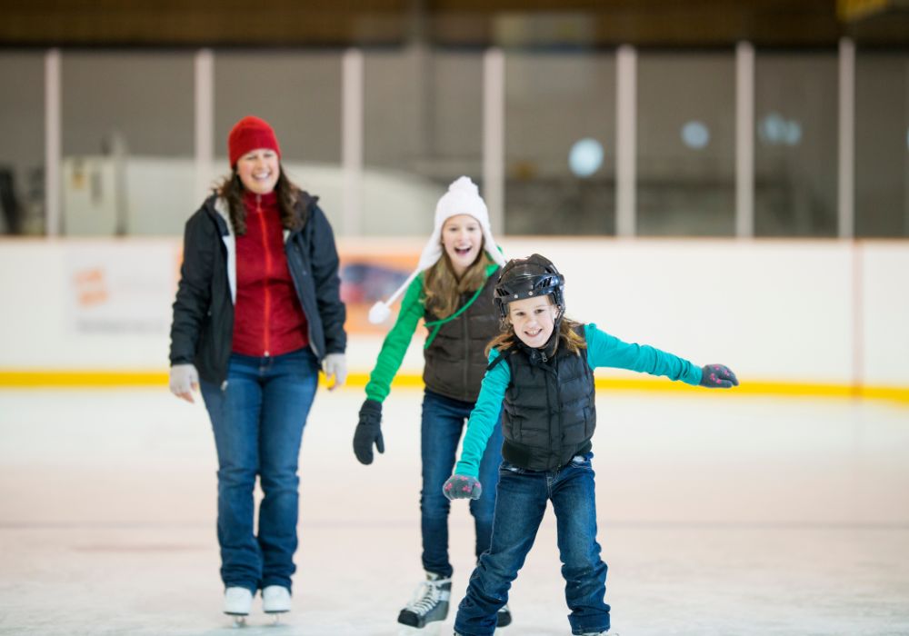 People are having fun on skating rink.