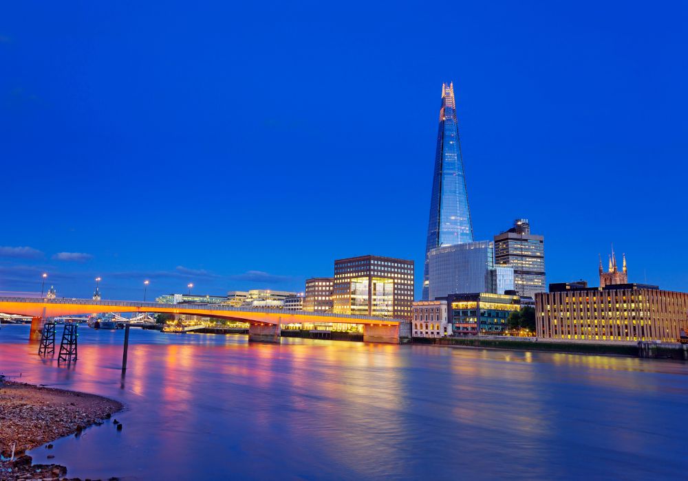 View of the Shard which is one of London's newest skyscrapers and London Bridge at dusk.