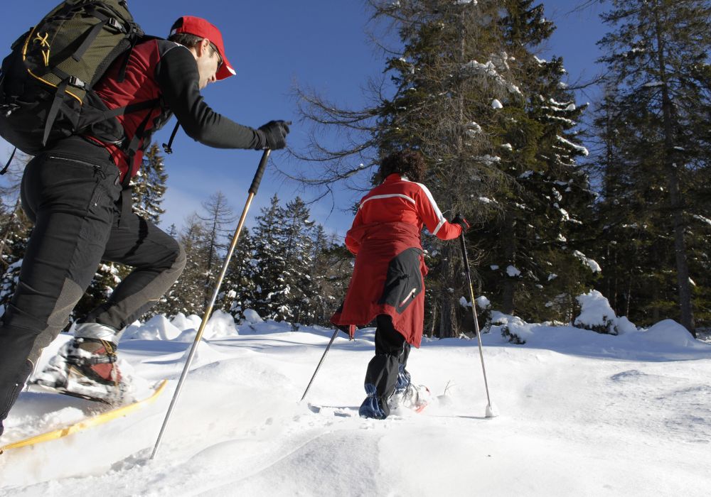 A couple out snowshoeing after a fresh snowfall.