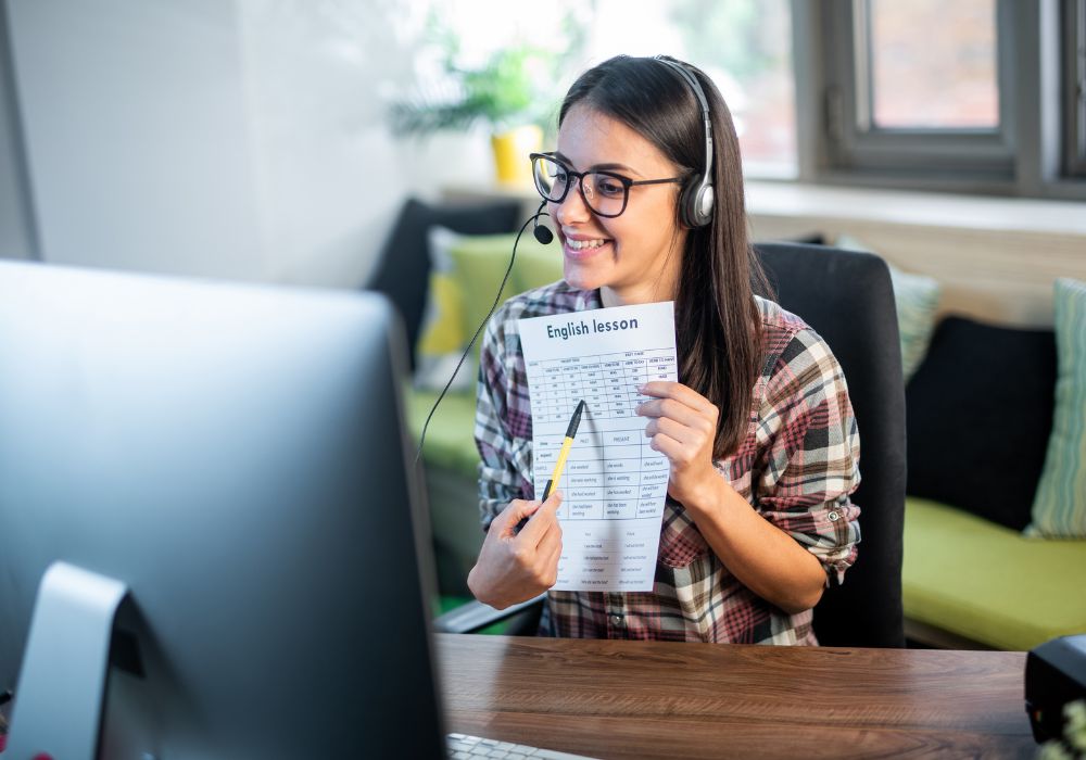 Young English teacher giving online lessons.