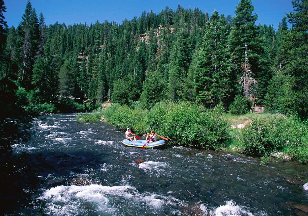 Tourists are having fun doing whitewater rafting.