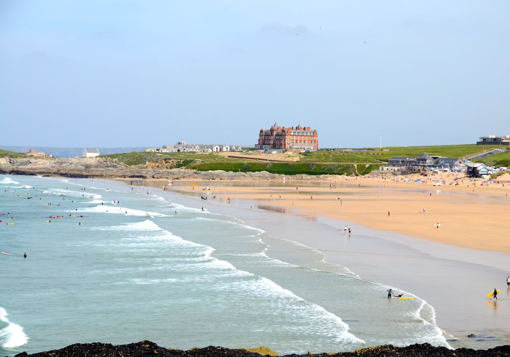 fistral beach with rolling waves and castle