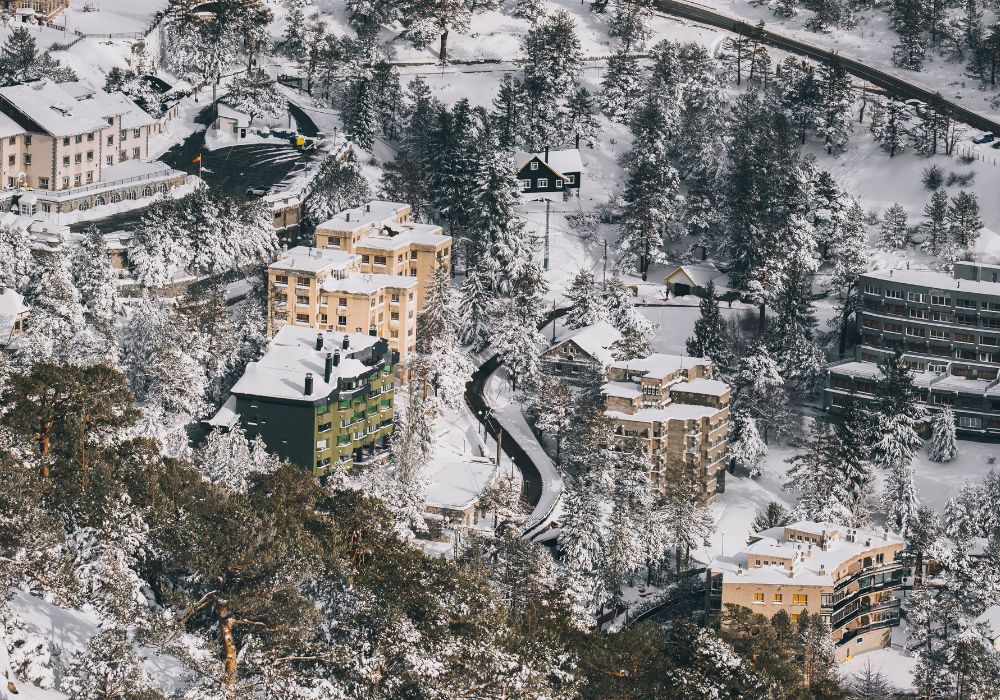 Puerto de Navacerrada village at sunset after winter snowfall in Madrid.