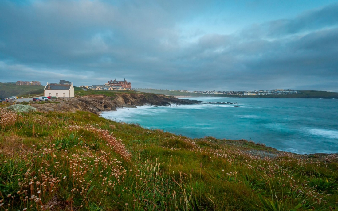 Newquay Headland, Cornwall, at sunset during summer on a gloomy day.
