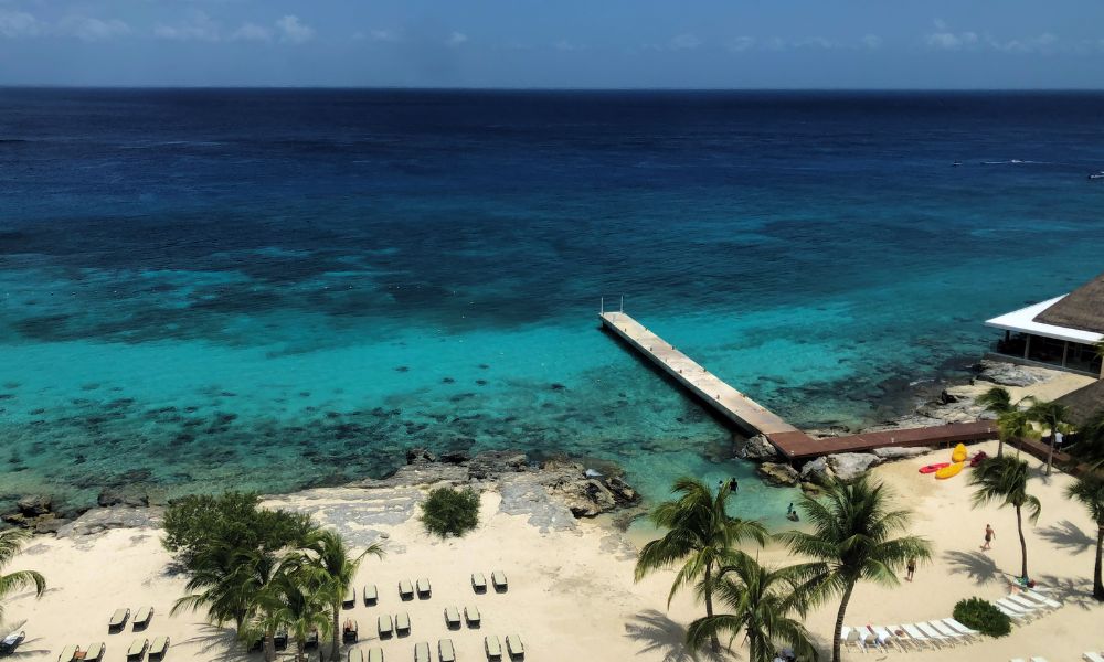 beach club in cozumel with ocean and chairs