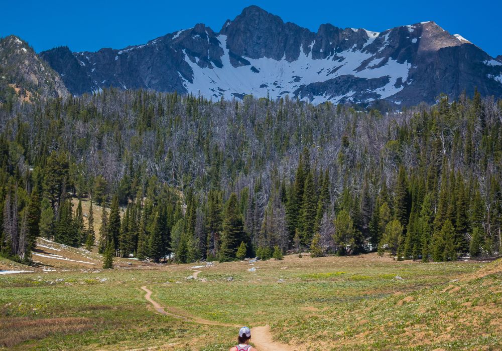 A girl hiking toward Beehive Basin, above Big Sky Resort, Montana.