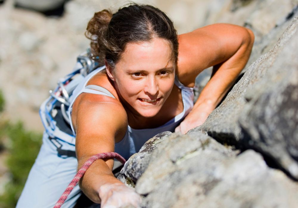 A woman rock climbing.