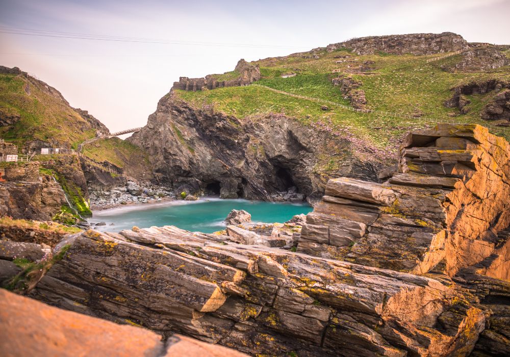 The ruins of Tintagel Castle on Tintagel Island at sunset.