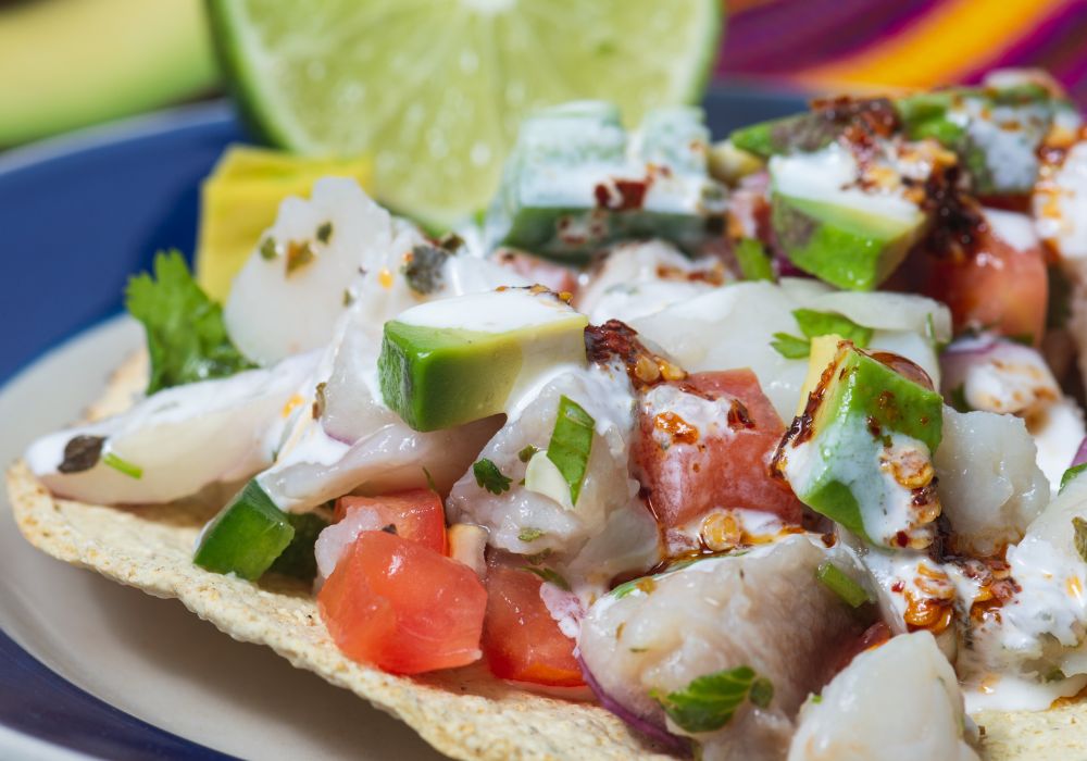 Mexican fish ceviche marinated in lime juice with raw onion with crispy fried tortillas.