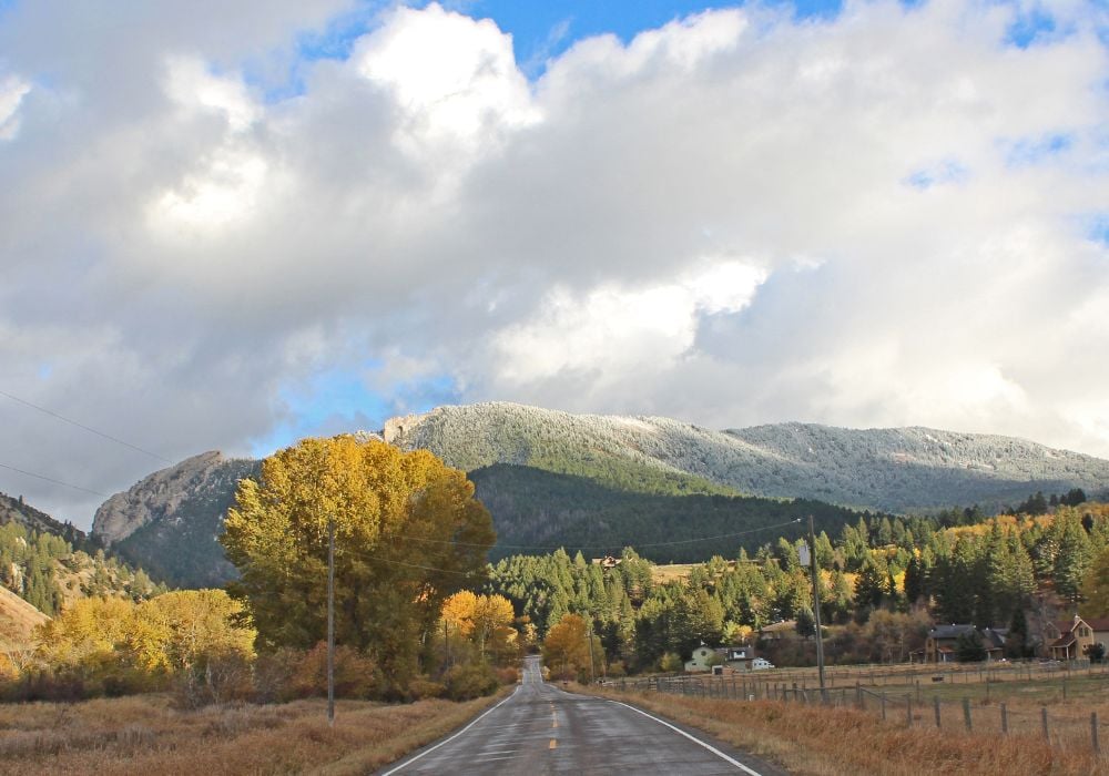 A picture with frosty trees on the Gallatin Mountains on the right side of the picture with Frog Rock.