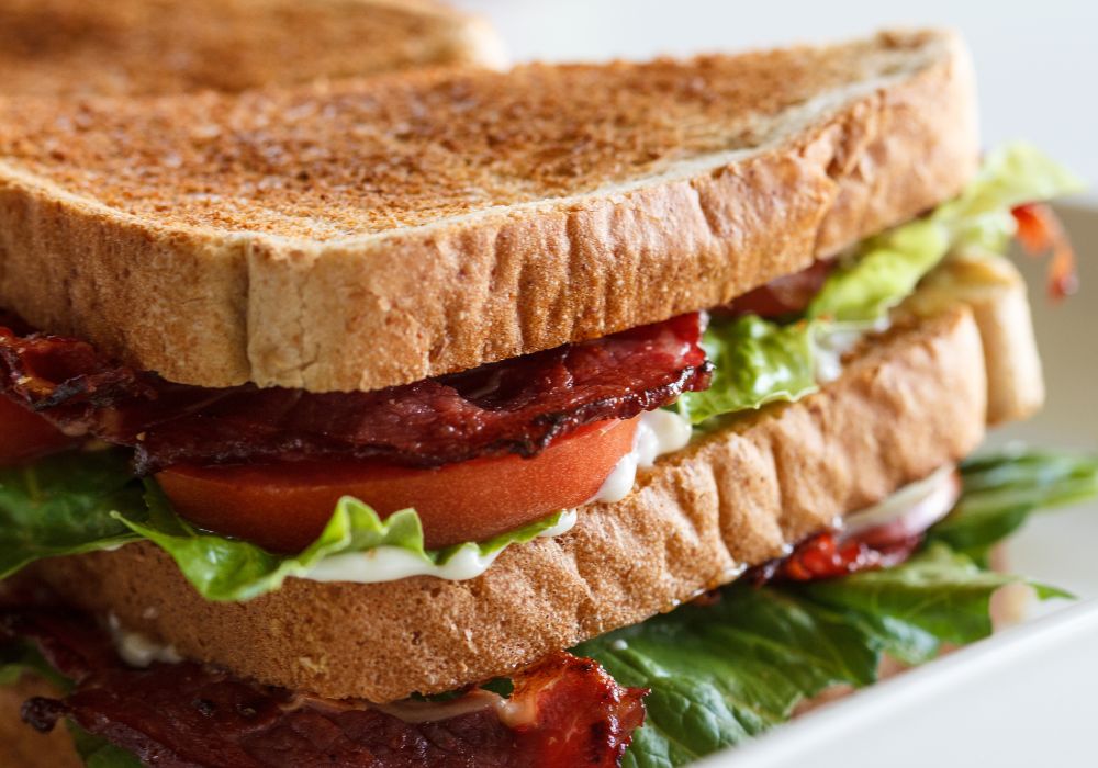 BLT club sandwich with lettuce tomato and bacon.