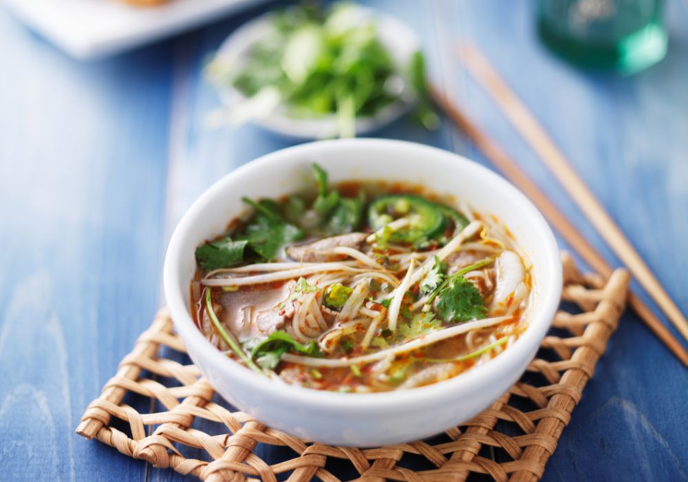 A bowl of Vietnamese pho with sliced beef.