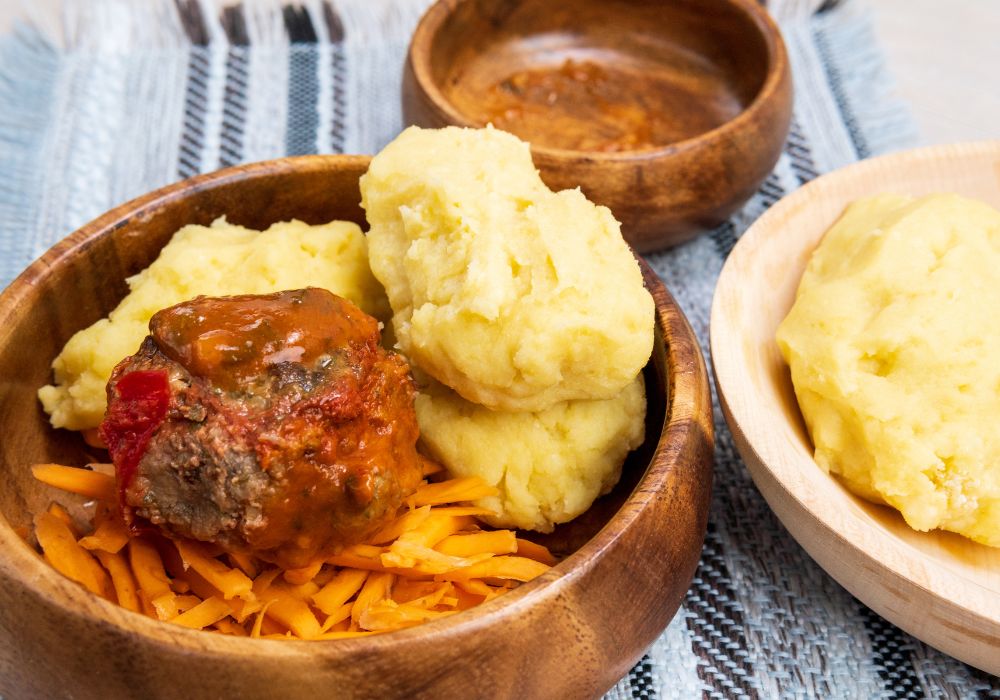 Ugly and sukuma wiki, maize flour porridge with meat and sweet potatoes, Zambian cuisine, traditional African dishes