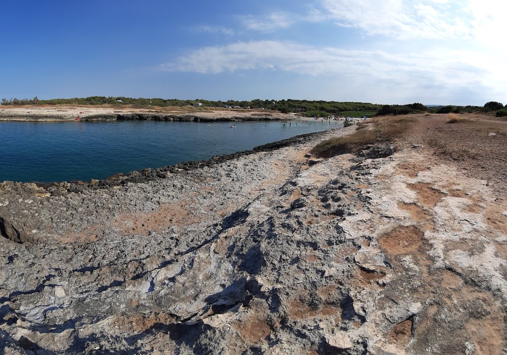 A panoramic view of the beautiful Spiaggia di Torre Pozzelle in Ostuni, Italy.