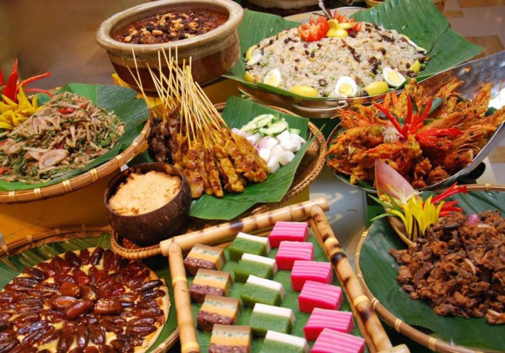 A variety of Malaysian food is served on a table.