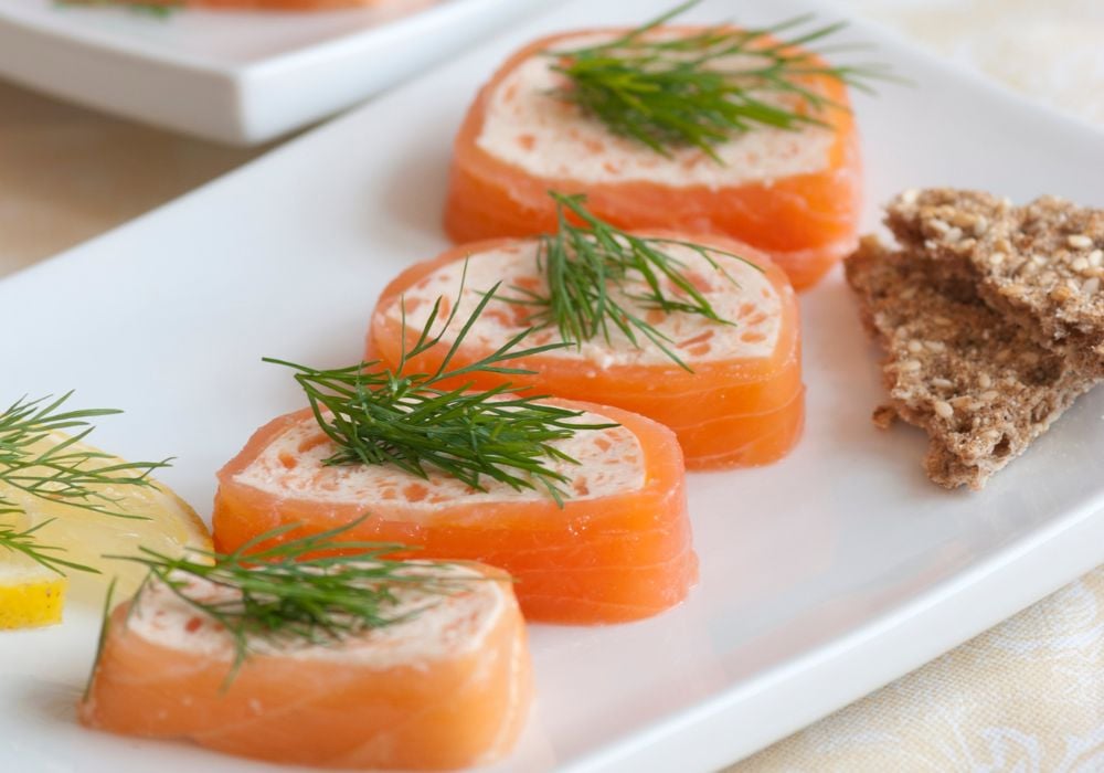 salmon pate with dill, lemon and crispbread on a plate