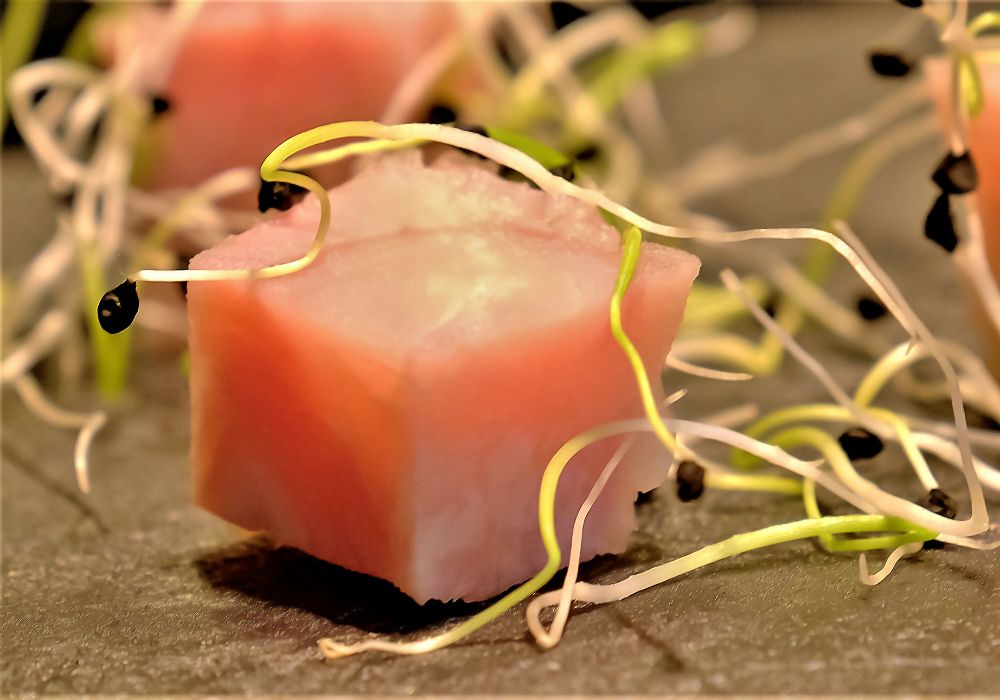 Diced York ham with garlic sprouts on a stone tray