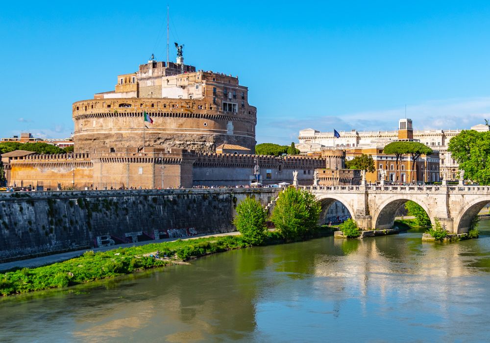 Walk across the Castle Sant Angelo and Ponte Sant Angelo, reflected in Tiber River in Rome, Italy.