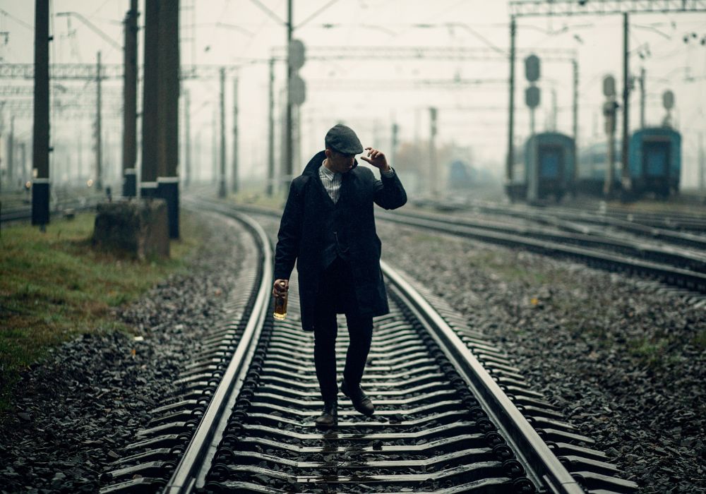 A man walking along a railway carriage for England's 1920s theme