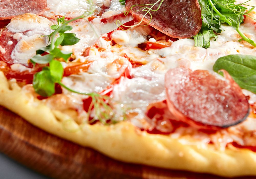 Prosciutto Funghi Pizza on a wooden board