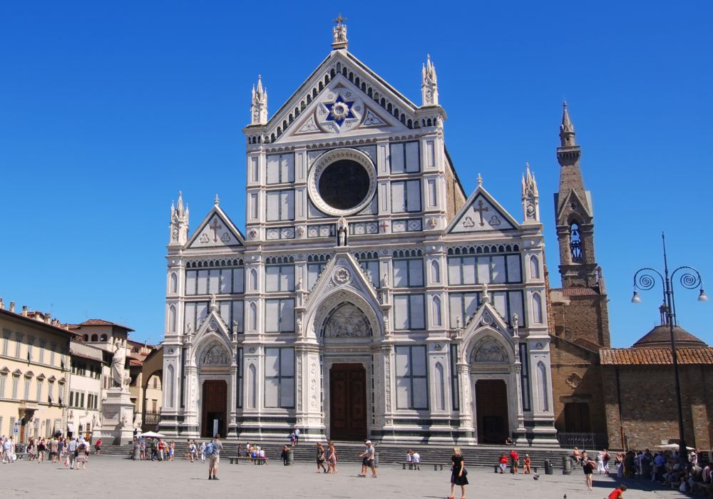 The magnificent Basilica di Santa Croce under a bright blue sky.