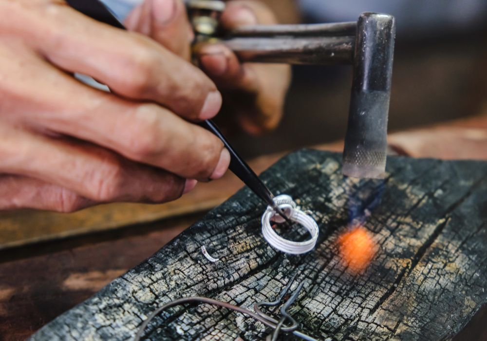 Close up hand of silversmith making a silver ring