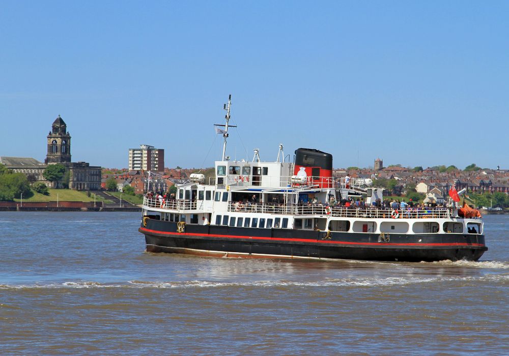 The world famous Mersey ferry gently turns to head for seacombe in a beautiful summers day.