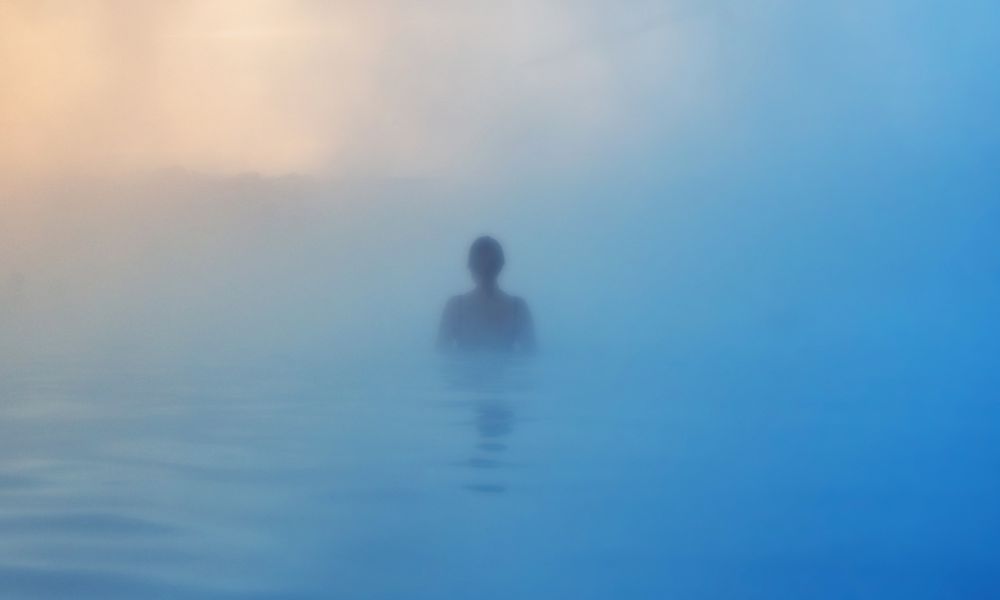 Woman relaxing in the steam of Bozeman Hot Springs